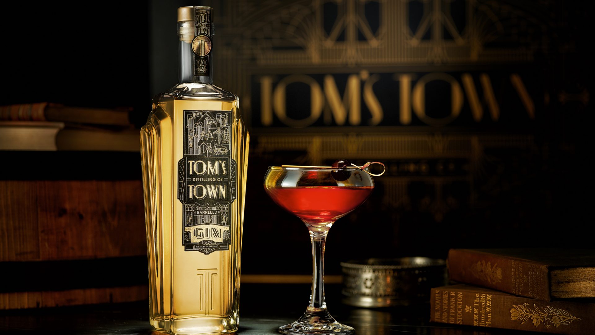 Tom's Town Distilling Co: Spirits Branding Bottle, Glass on the table